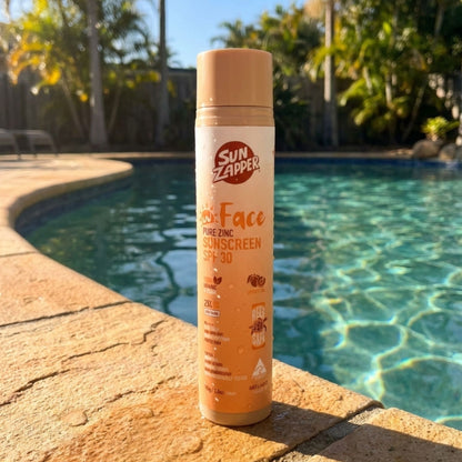 Sun Zapper sunscreen bottle by a poolside mineral face sun cream spf 30